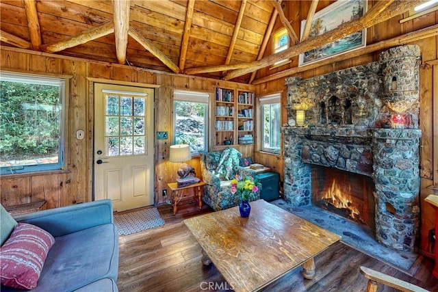 interior space with hardwood / wood-style floors, vaulted ceiling with beams, wooden walls, and wooden ceiling