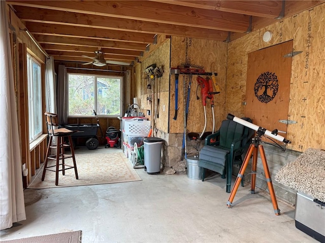 miscellaneous room with concrete flooring and a ceiling fan