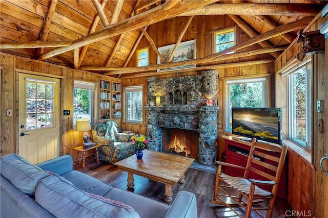 living area with beamed ceiling, wooden walls, hardwood / wood-style flooring, and wooden ceiling