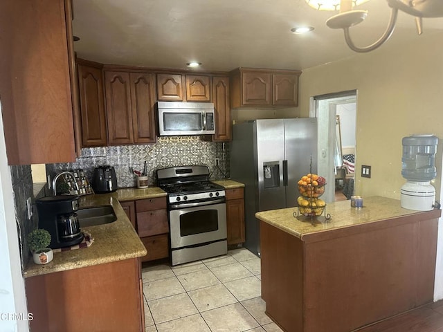 1014 Rialto St, Oxnard, CA 93035 - kitchen with tasteful backsplash, stainless steel appliances, light tile patterned flooring, and a sink