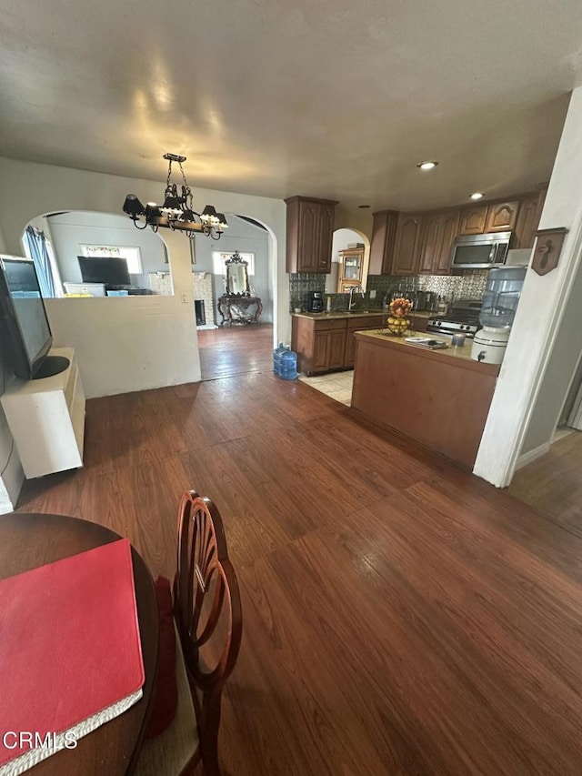 1014 Rialto St, Oxnard, CA 93035 - dining area with dark wood finished floors, recessed lighting, arched walkways, and a notable chandelier