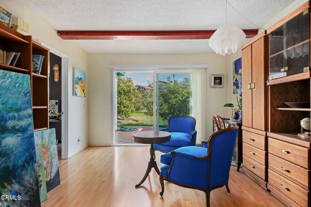1126 Lawrence Way, Oxnard, CA 93035 - living area with light wood-style floors, a textured ceiling, beamed ceiling, and a chandelier