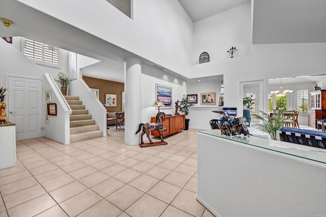 4981 Lamia Way, Oceanside, CA 92056 - foyer entrance featuring a towering ceiling, stairs, light tile patterned floors, and a chandelier