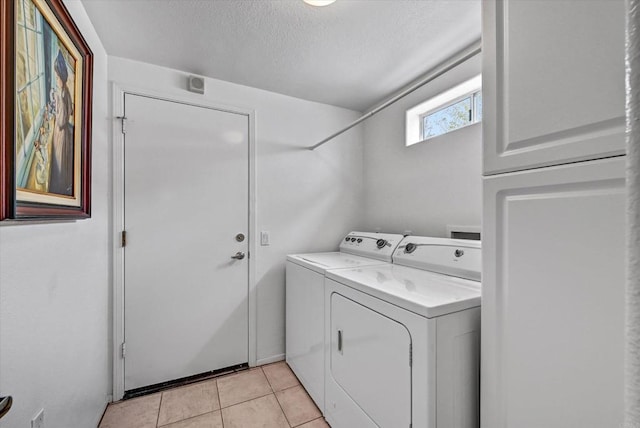 4981 Lamia Way, Oceanside, CA 92056 - laundry room with washer and clothes dryer, a textured ceiling, and light tile patterned floors