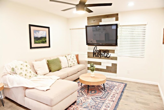 living area with recessed lighting, wood finished floors, baseboards, and ceiling fan