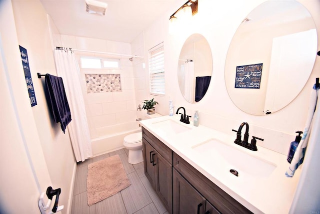 full bathroom featuring double vanity, toilet, shower / tub combo with curtain, and a sink