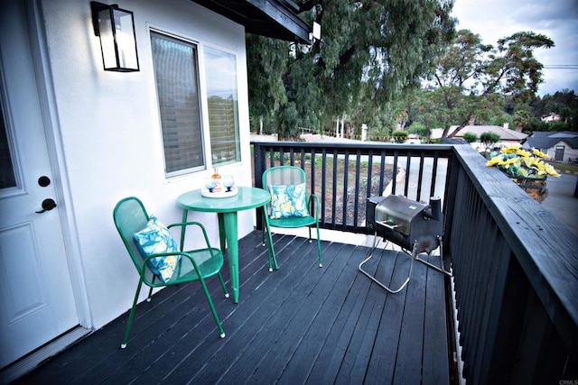 wooden deck with a grill