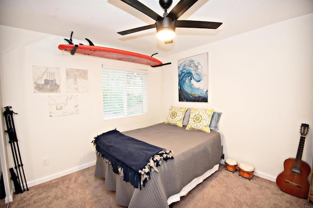 carpeted bedroom with baseboards and ceiling fan