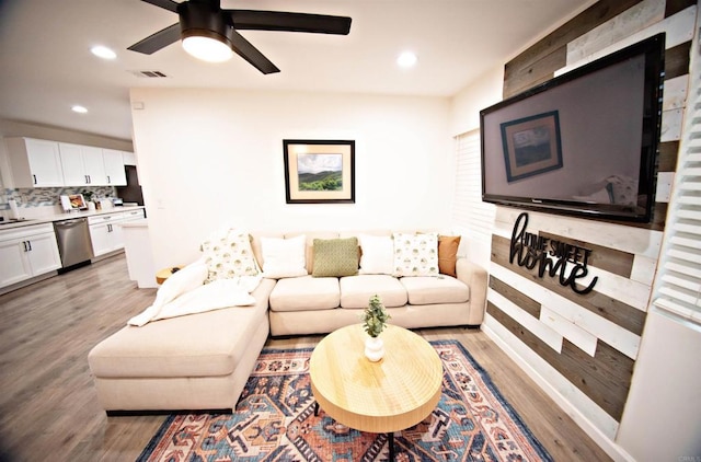 living area with recessed lighting, a ceiling fan, visible vents, and light wood-type flooring