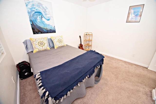 carpeted bedroom featuring baseboards