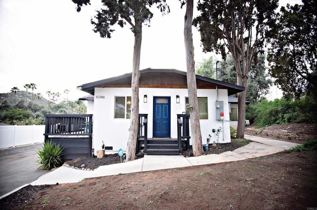 view of front of property with stucco siding and fence