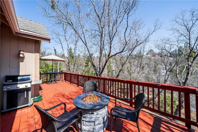 28136 N Bay Rd, Lake Arrowhead, CA 92352 - wooden deck with a fire pit and area for grilling