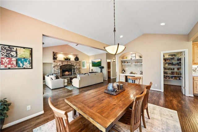 28136 N Bay Rd, Lake Arrowhead, CA 92352 - dining room featuring lofted ceiling, a fireplace, dark wood finished floors, baseboards, and built in features