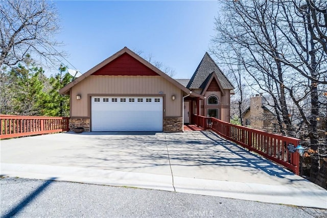 28136 N Bay Rd, Lake Arrowhead, CA 92352 - chalet / cabin featuring stone siding, an attached garage, and concrete driveway
