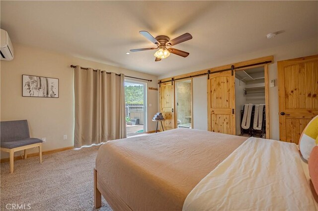 carpeted bedroom featuring a barn door, access to exterior, ceiling fan, a wall mounted AC, and baseboards