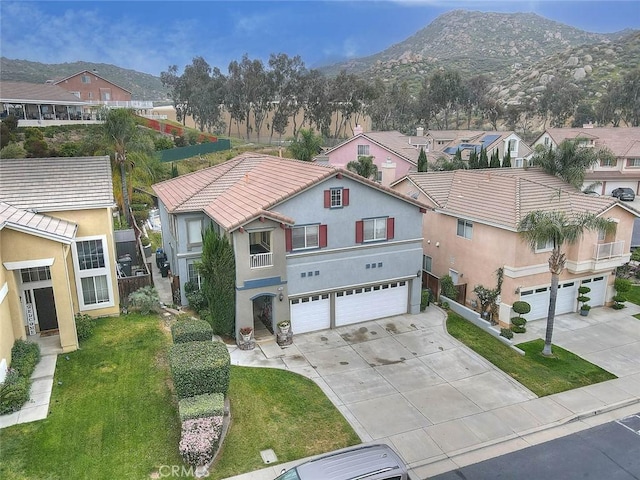 view of front facade with a garage, a residential view, driveway, and stucco siding