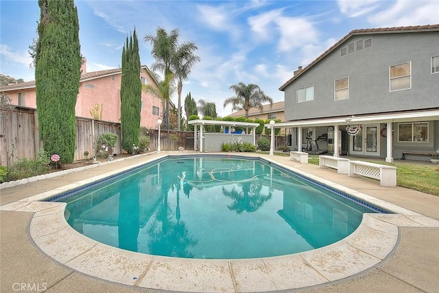 view of pool with a fenced in pool, french doors, a patio, and a fenced backyard