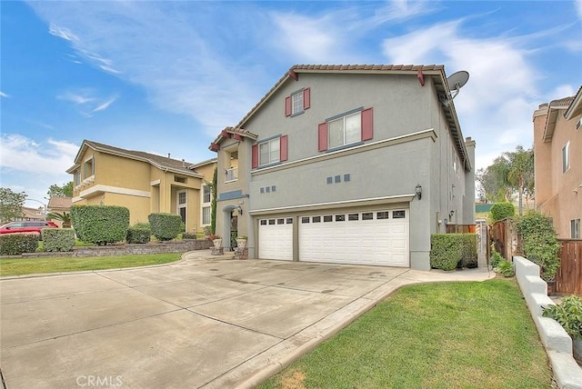 mediterranean / spanish-style house featuring stucco siding, driveway, fence, and a garage