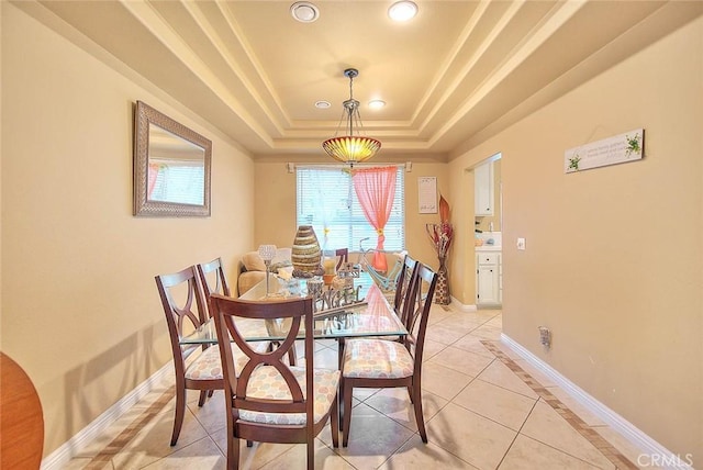 dining space with recessed lighting, a tray ceiling, light tile patterned flooring, crown molding, and baseboards