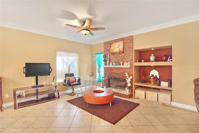 tiled living room featuring a ceiling fan, crown molding, built in shelves, a fireplace, and baseboards