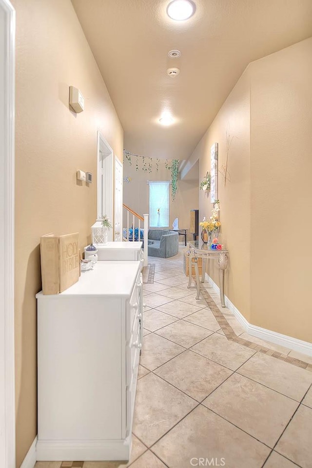 corridor featuring recessed lighting and light tile patterned floors