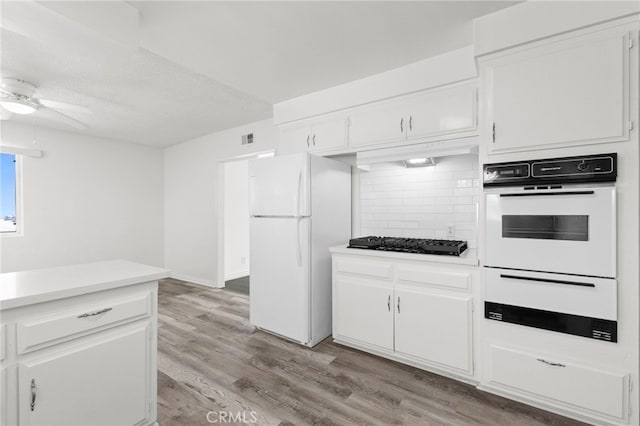 1729 S Alma St, San Pedro, CA 90731 - kitchen with white appliances, a ceiling fan, decorative backsplash, light countertops, and light wood-style floors