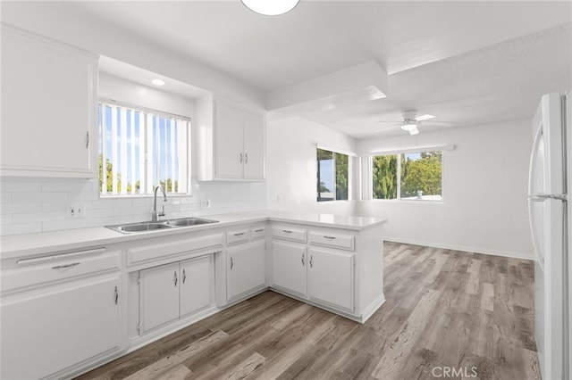 1729 S Alma St, San Pedro, CA 90731 - kitchen featuring freestanding refrigerator, backsplash, light wood-type flooring, a peninsula, and light countertops