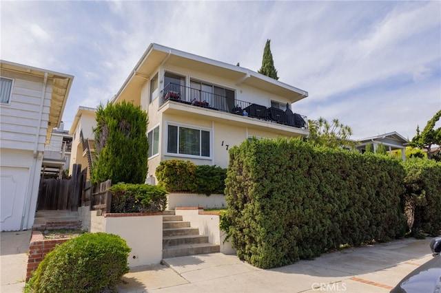 1729 S Alma St, San Pedro, CA 90731 - view of front of home featuring a balcony, stucco siding, and stairs