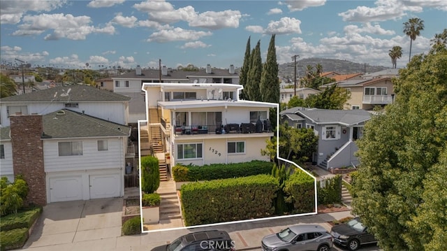 1729 S Alma St, San Pedro, CA 90731 - view of front of property with stairs, a residential view, a garage, driveway, and stucco siding