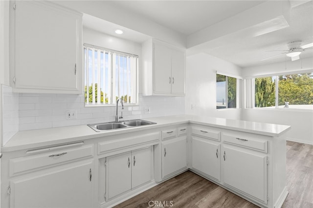 1729 S Alma St, San Pedro, CA 90731 - kitchen featuring white cabinets, decorative backsplash, light countertops, light wood finished floors, and recessed lighting