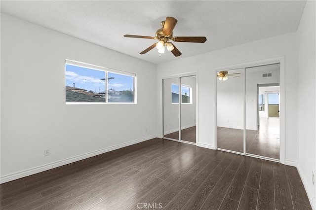 1729 S Alma St, San Pedro, CA 90731 - unfurnished bedroom with two closets, dark wood-type flooring, and ceiling fan