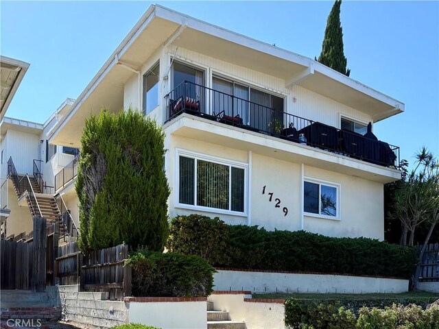 1729 S Alma St, San Pedro, CA 90731 - view of front of home featuring a balcony, stucco siding, and stairs