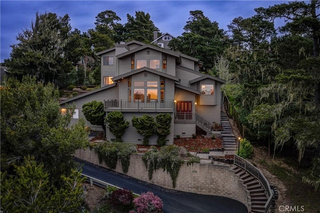 rear view of property featuring stairs