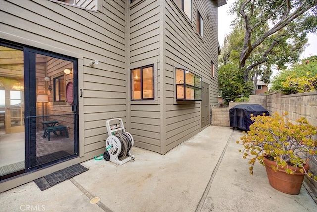 exterior space with area for grilling and fence