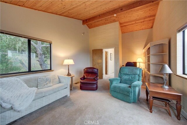 carpeted living area with wood ceiling, vaulted ceiling with beams, and a healthy amount of sunlight