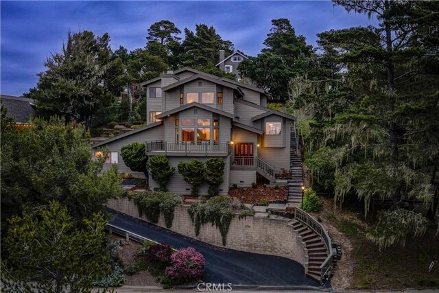 back of house featuring stairway