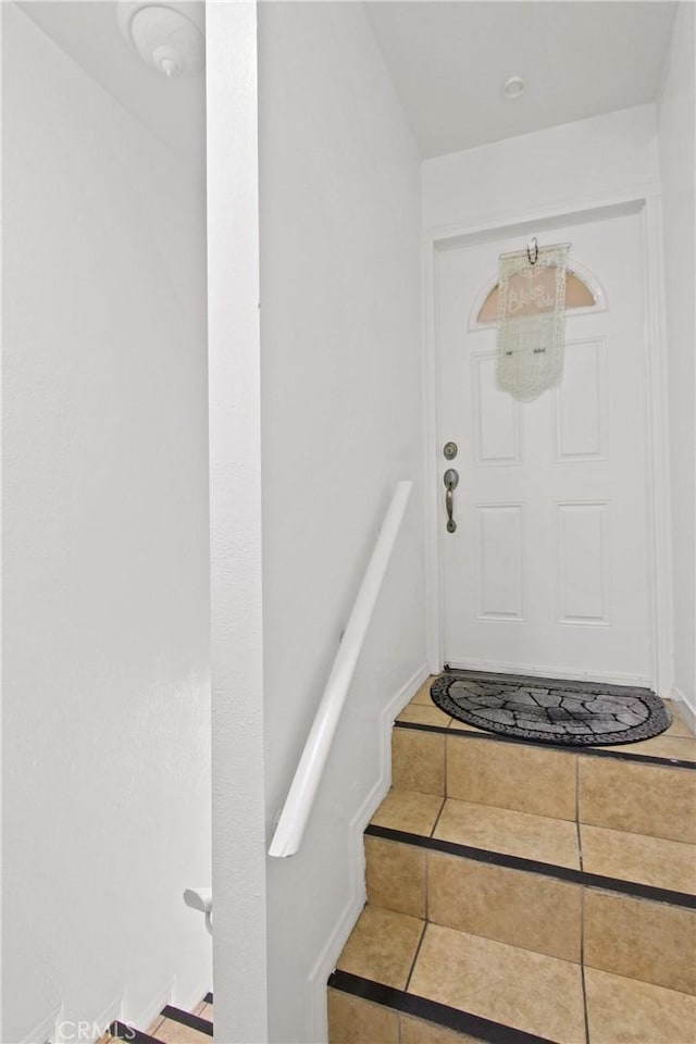 stairway with tile patterned flooring