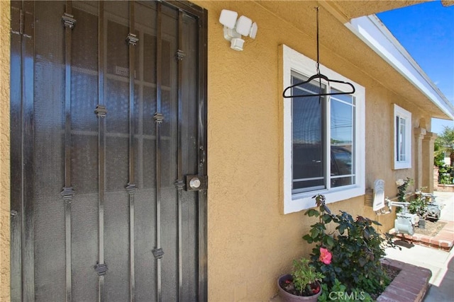 property entrance with stucco siding