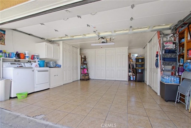 garage with washer and dryer and a garage door opener