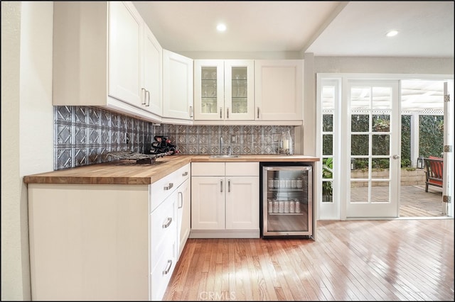 23962 Lanteen Cir, Laguna Niguel, CA 92677 - indoor bar with wine cooler, light wood-style flooring, decorative backsplash, and recessed lighting