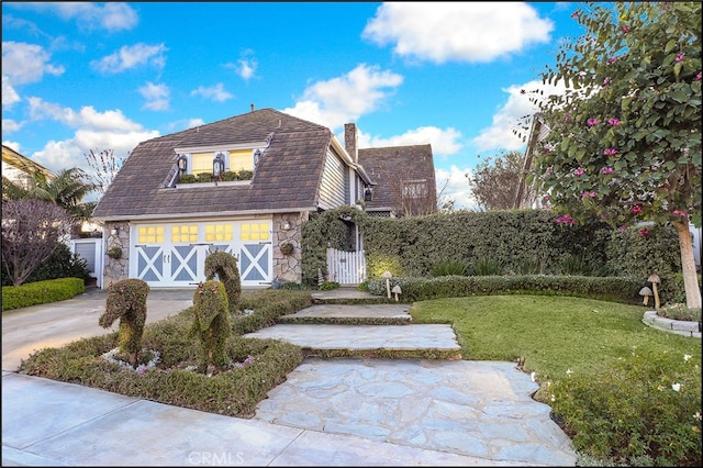 23962 Lanteen Cir, Laguna Niguel, CA 92677 - view of front of property featuring stone siding, a chimney, a front lawn, driveway, and a garage