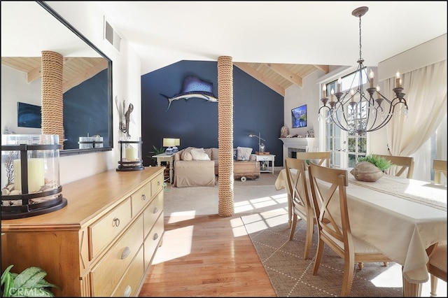 23962 Lanteen Cir, Laguna Niguel, CA 92677 - dining space featuring a chandelier, light wood-style flooring, wooden ceiling, and a fireplace