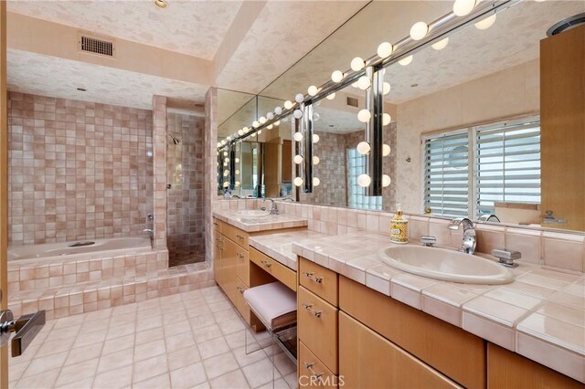 812 W Bay Ave, Newport Beach, CA 92661 - bathroom with a relaxing tiled tub, a tile shower, tile patterned floors, visible vents, and vanity