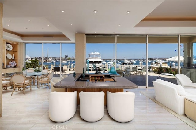 812 W Bay Ave, Newport Beach, CA 92661 - dining area featuring a raised ceiling, floor to ceiling windows, and a wealth of natural light