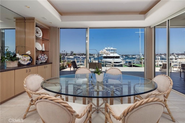 812 W Bay Ave, Newport Beach, CA 92661 - dining area featuring a tray ceiling, a wealth of natural light, and a wall of windows