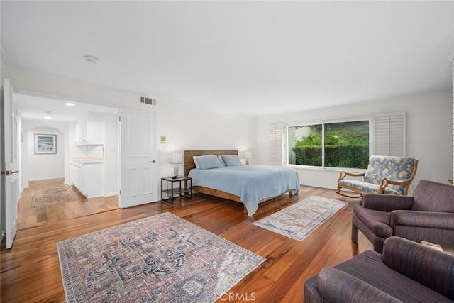 bedroom with light wood-style flooring and visible vents