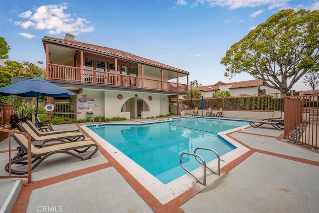 pool featuring a patio area and fence