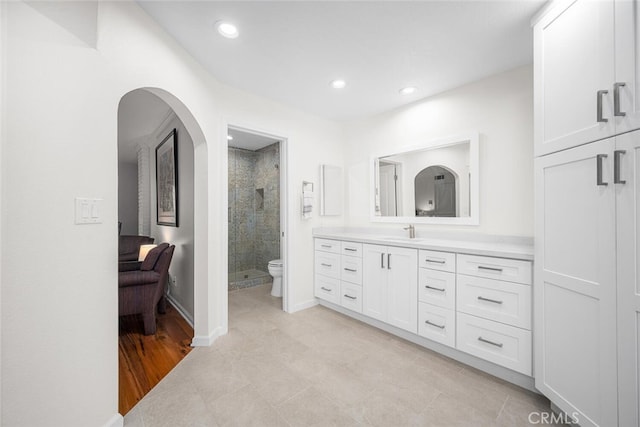 full bathroom with vanity, toilet, a stall shower, recessed lighting, and ensuite bath