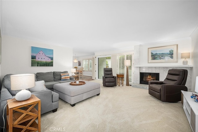 living room with a fireplace, carpet floors, and ornamental molding