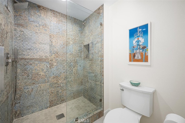 full bathroom featuring toilet and tiled shower